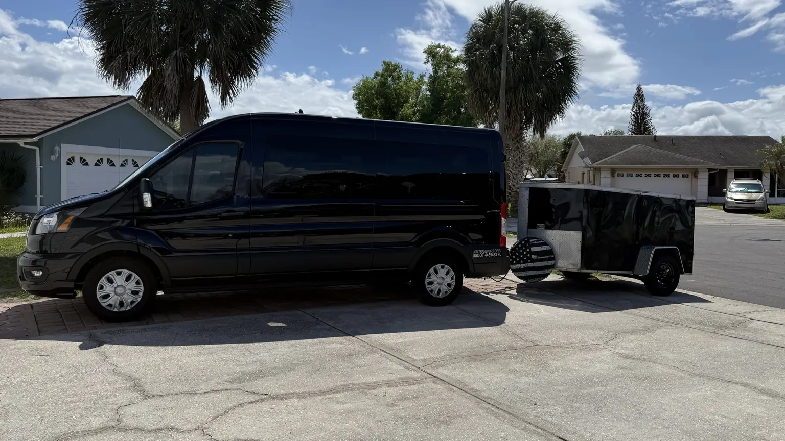 JOB's Ford Transit van with its enclosed luggage trailer hitched behind